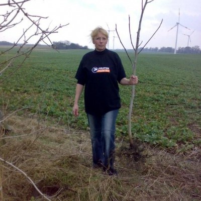 Petra Wirth, (kommissarische) stellvertretende Vorsitzende des KV MOL pflanzt einen Baum in Herzberg.